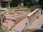 wheelchair ramp rails cleaned and painted with 2 coats solid stain